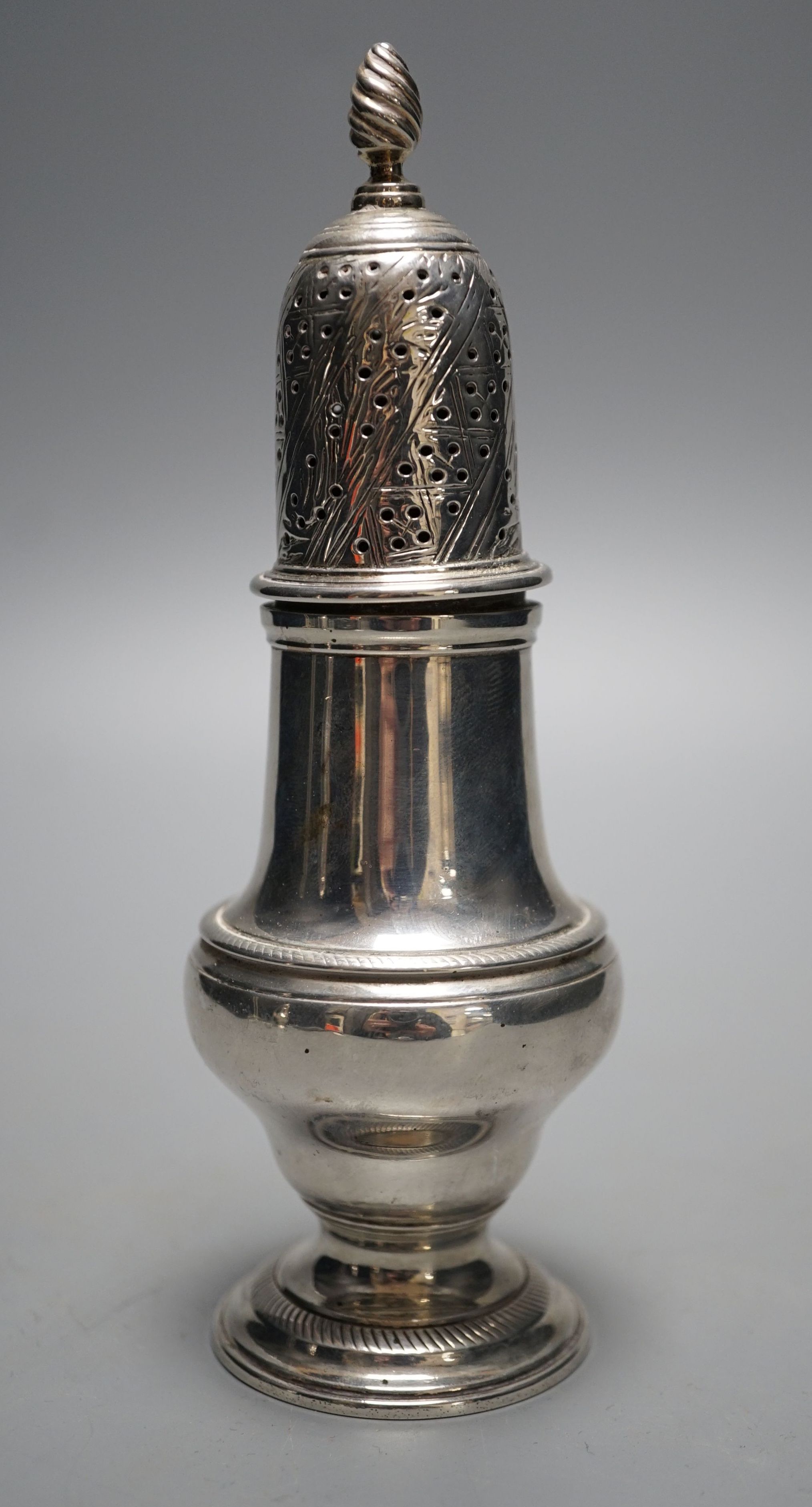 An early George III silver pepper, with interior cap with finial, by John Delmester, London, 1760, 15.5cm, 4.5oz.
